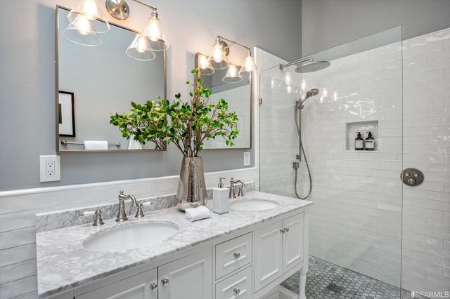 a view of a patio with couches table and chairs potted plants and large tree