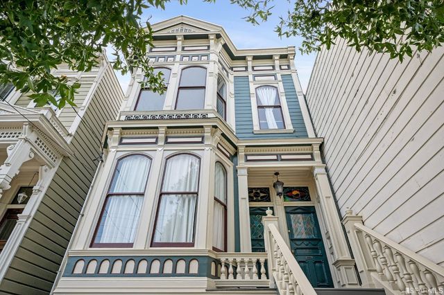 a balcony with furniture and potted plants