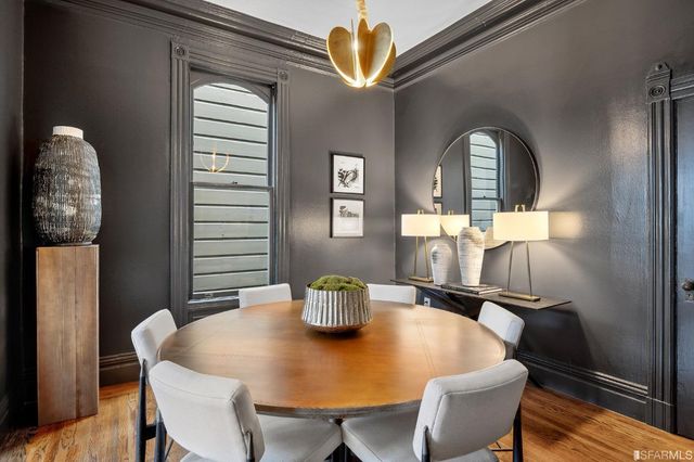 a view of a dining room with furniture and a window