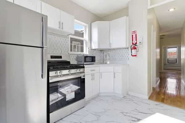 a kitchen with cabinets and appliances