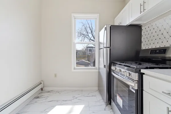 a kitchen with a stove and a refrigerator