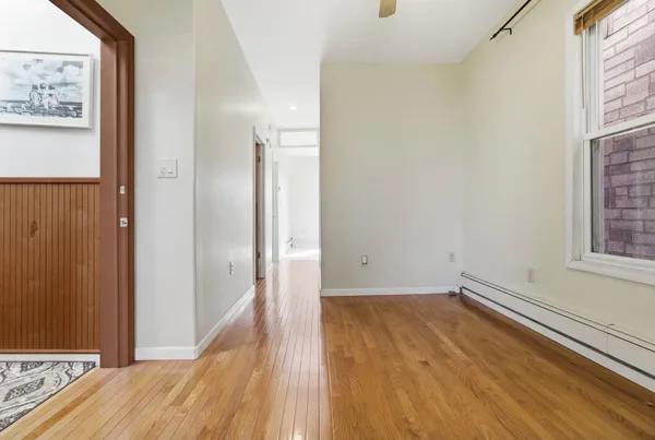 a view of a room with wooden floor and small space