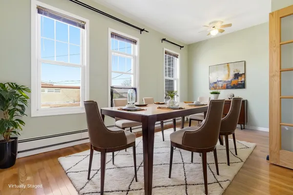 a view of a dining room with furniture and wooden floor