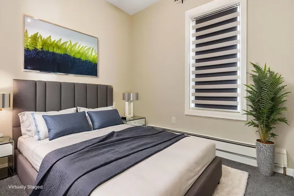 a bedroom with a bed and a flat tv screen