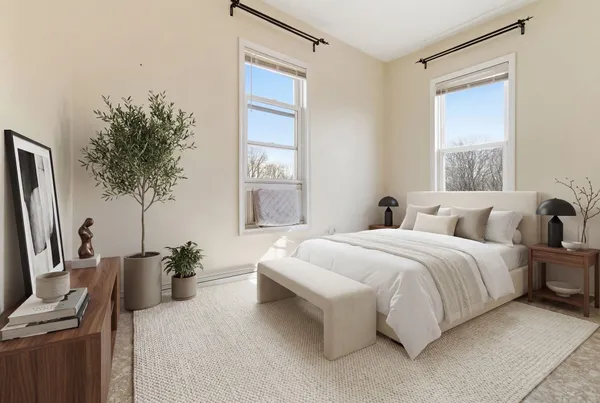 a bedroom with a bed and a potted plant