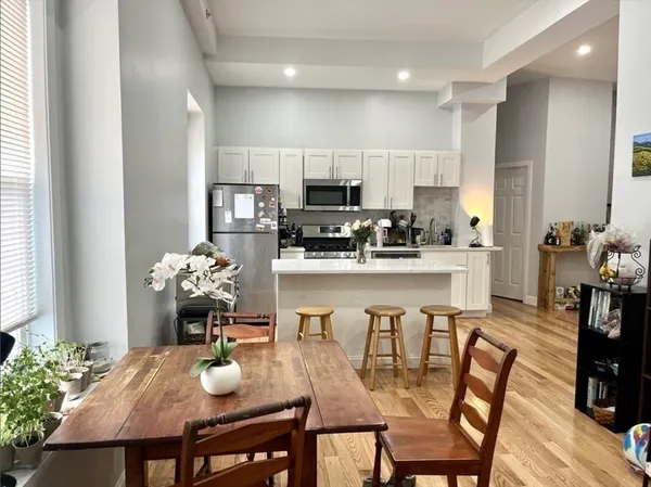 a view of a dining room with furniture and wooden floor