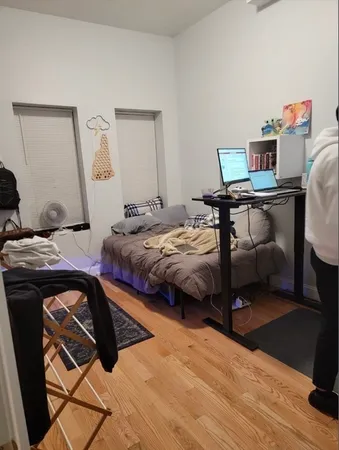 a bedroom with a bed and a desk