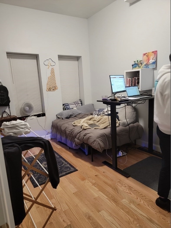 83 Highland Street, Unit 1 Boston, MA 02119 - Photo 6 of 9 a bedroom with a bed and a desk