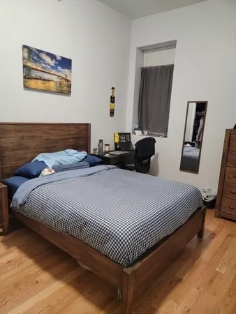 a bedroom with bed and a window