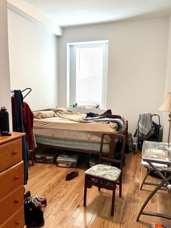 83 Highland Street, Unit 1 Boston, MA 02119 - Photo 9 of 9 a bedroom with a bed and furniture