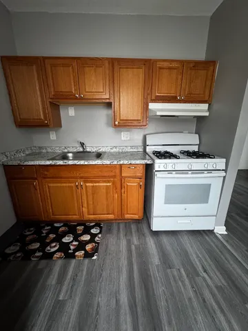 a kitchen with wooden cabinets and a stove top oven