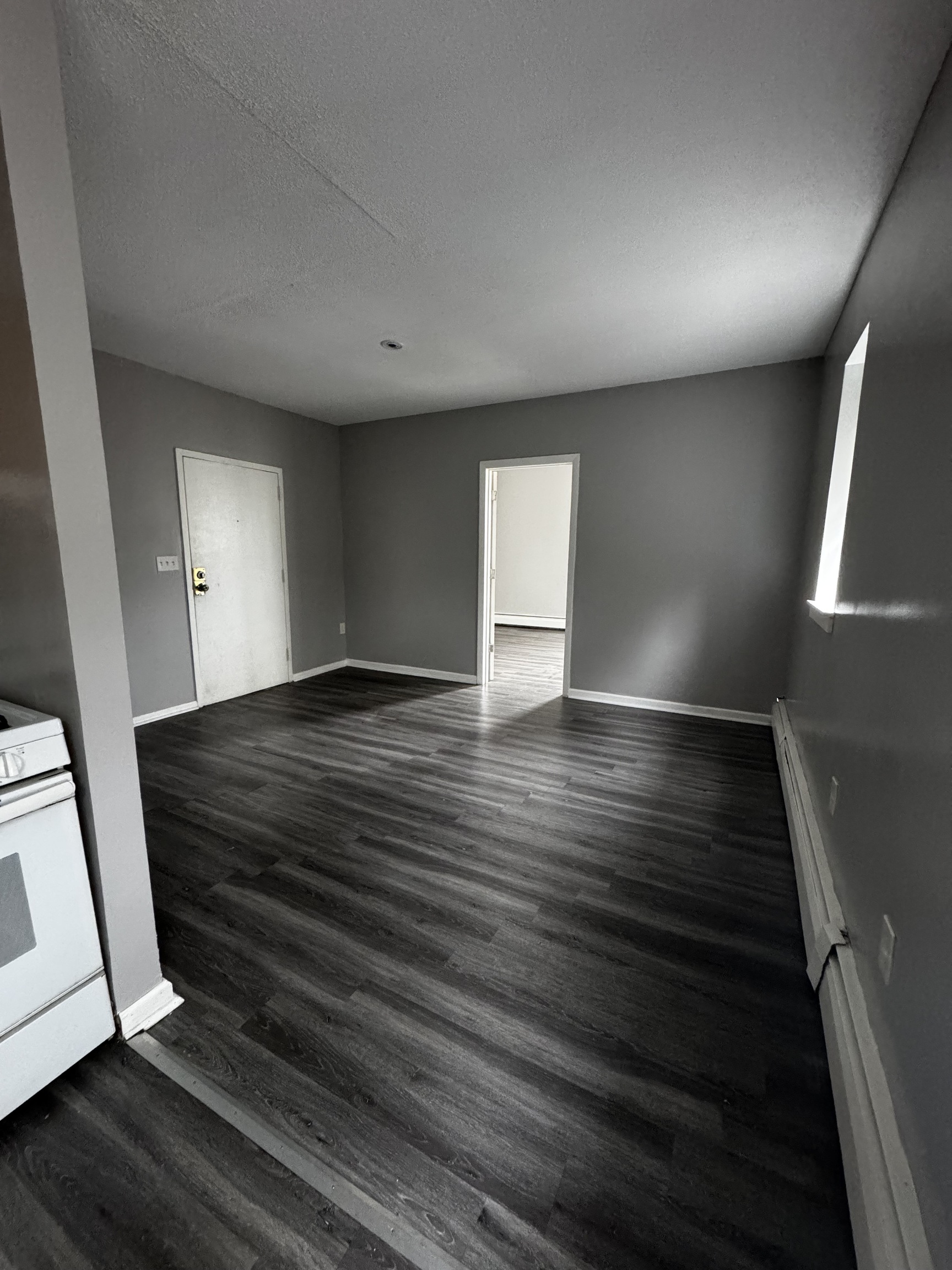 27 Congress Street, Unit 304 Hartford, CT 06114 - Photo 5 of 5 a view of an empty room with wooden floor and a window