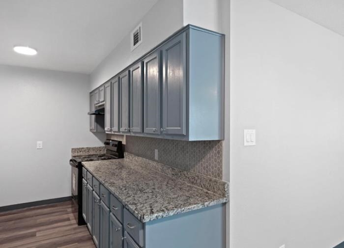 1283 East Raines Road Memphis, TN 38116 - Photo 6 of 23 a kitchen with granite countertop cabinets and utility