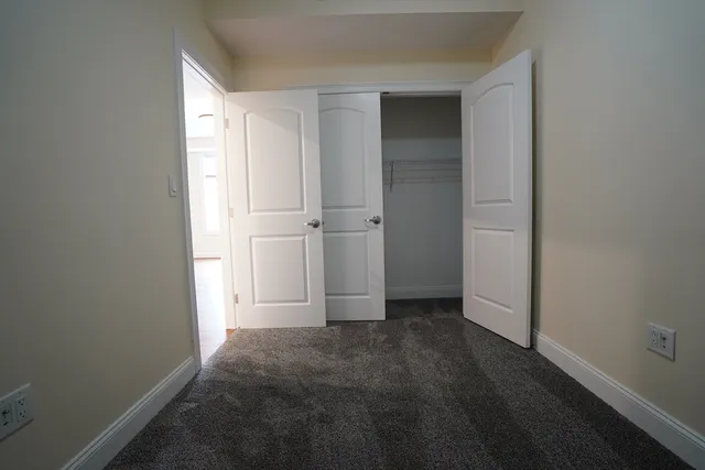 an empty room with closet area