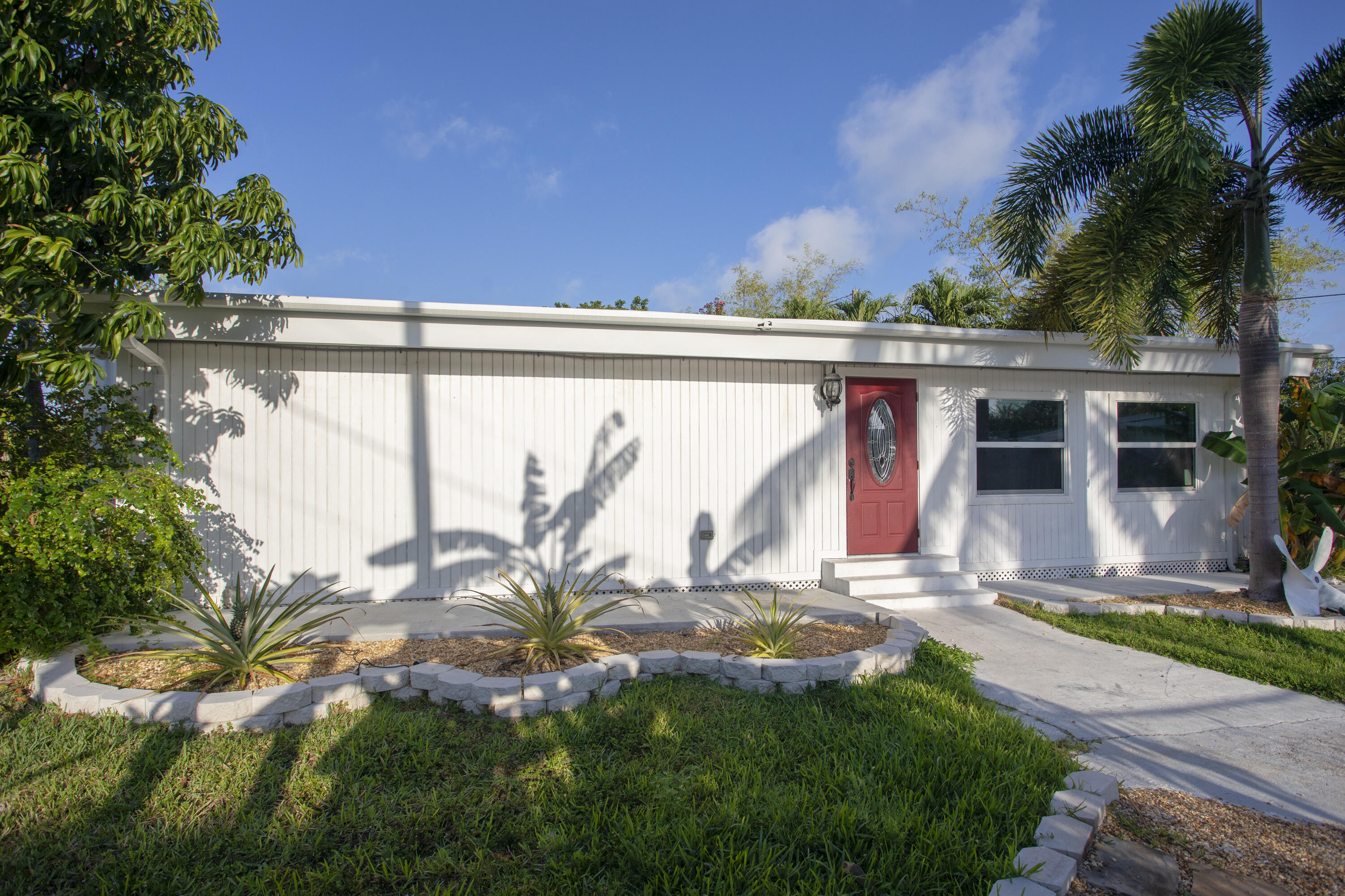 35 Dondi Road Key West, FL 33040 - Photo 2 of 15 a view of a house with a small yard and plants