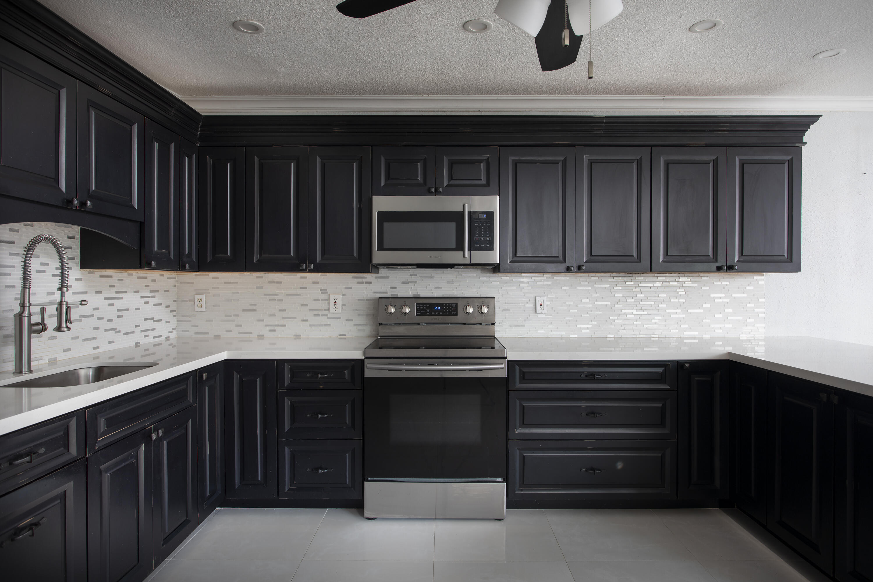 35 Dondi Road Key West, FL 33040 - Photo 6 of 15 a kitchen with granite countertop a stove and a sink