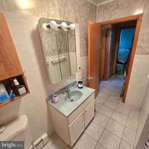 a bathroom with a sink vanity and toilet