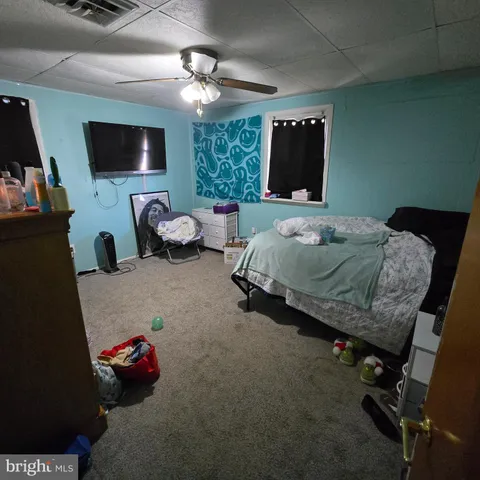 a bedroom with bed and tv