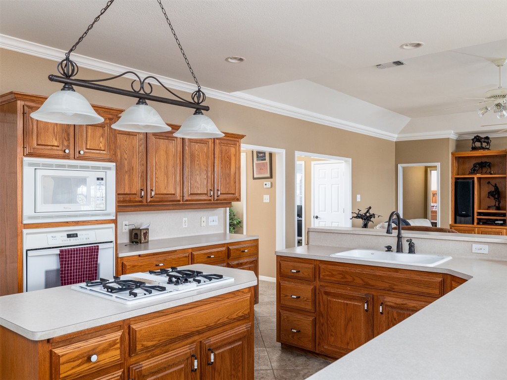 651 County Road 497 Taylor, TX 76574 - Photo 11 of 40 a kitchen with a stove a sink and a refrigerator