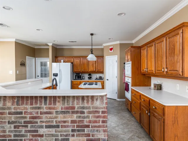a kitchen with stainless steel appliances a sink stove and cabinets