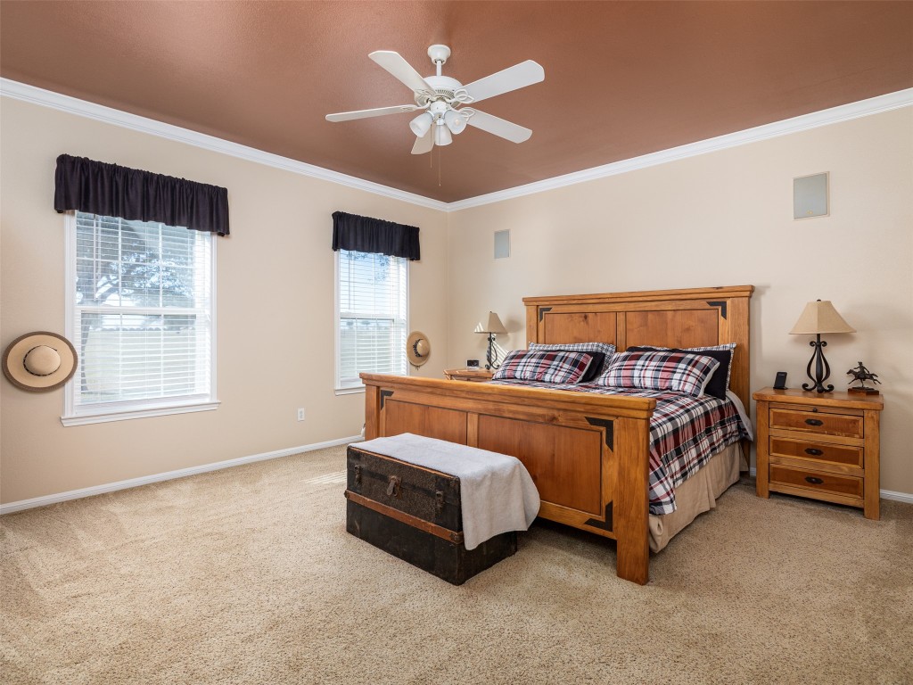 651 County Road 497 Taylor, TX 76574 - Photo 14 of 40 a bedroom with a bed and a ceiling fan