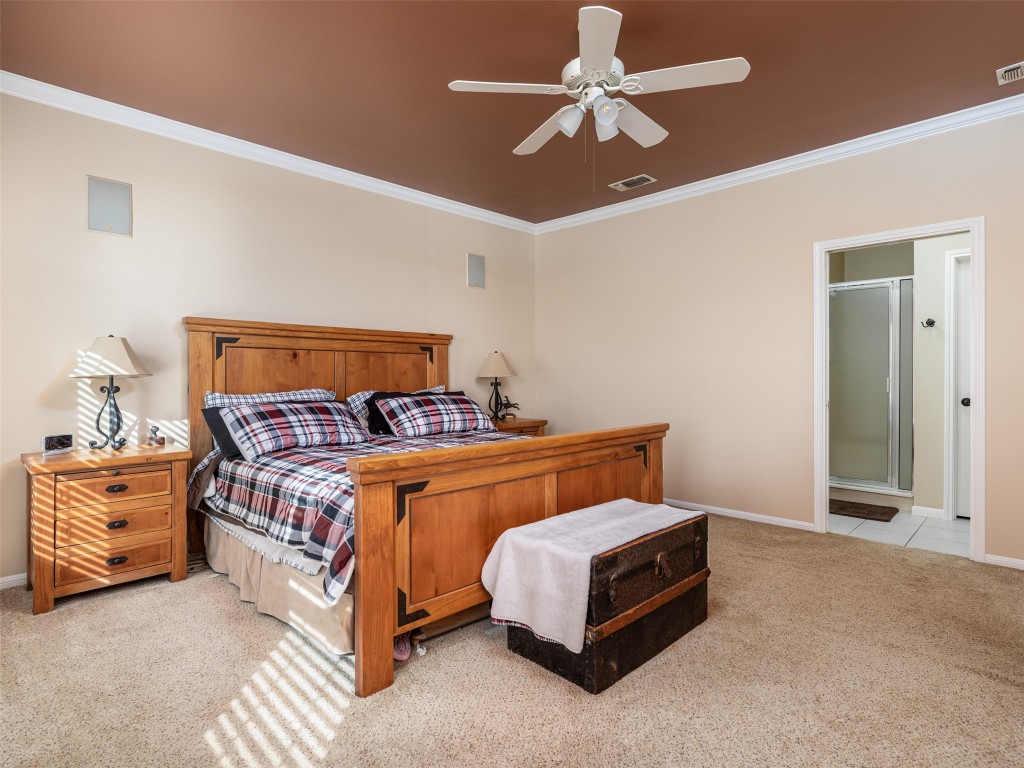 651 County Road 497 Taylor, TX 76574 - Photo 15 of 40 a bedroom with a bed and a chandelier