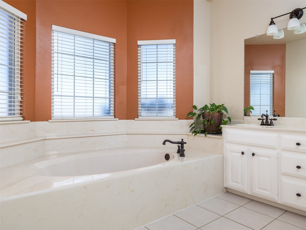 651 County Road 497 Taylor, TX 76574 - Photo 17 of 40 a bathroom with sink bathtub and window