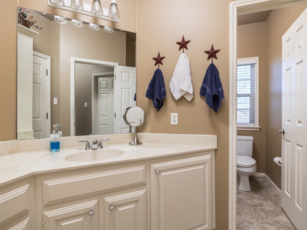 651 County Road 497 Taylor, TX 76574 - Photo 19 of 40 a bathroom with a sink a toilet and a mirror