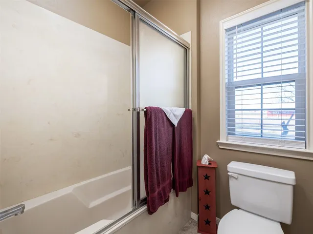 a bathroom with a toilet and a bathtub