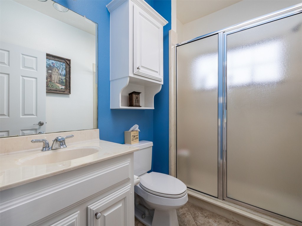 651 County Road 497 Taylor, TX 76574 - Photo 23 of 40 a bathroom with a sink mirror vanity and toilet