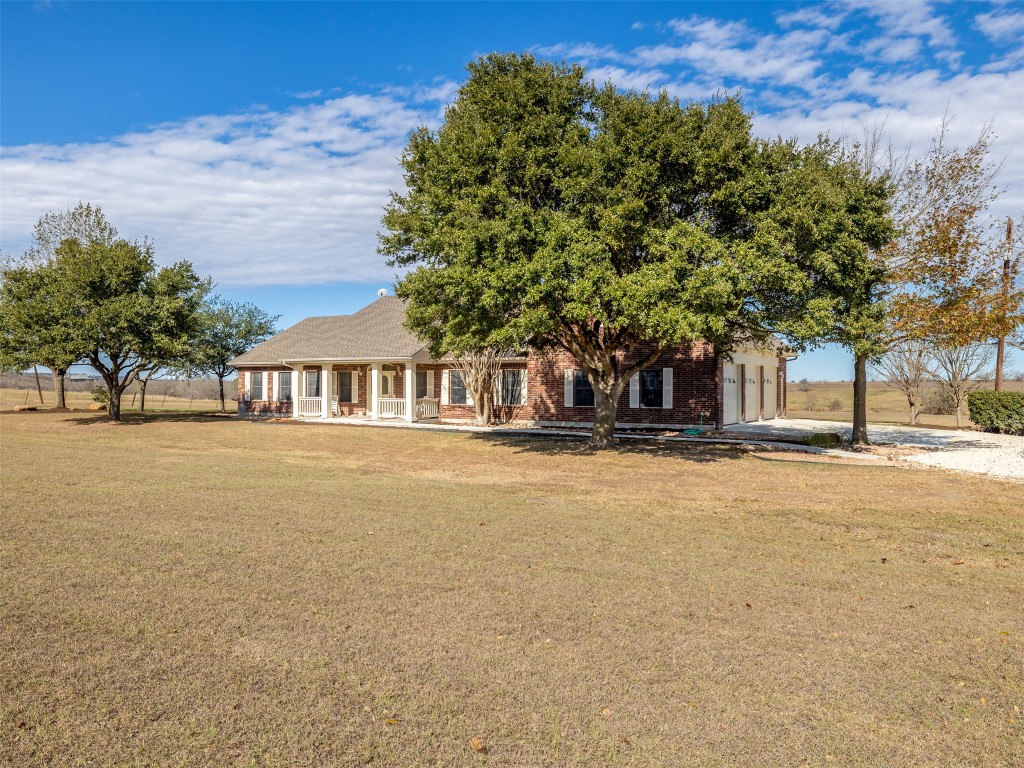 651 County Road 497 Taylor, TX 76574 - Photo 5 of 40 a front view of a house with a garden