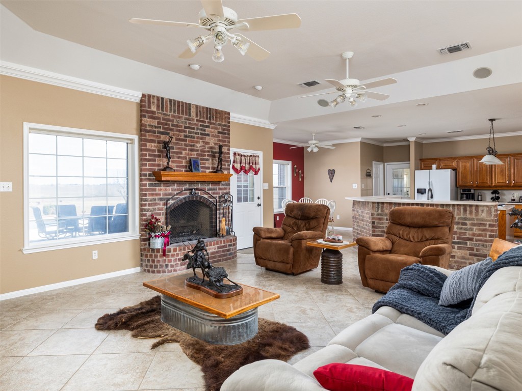 651 County Road 497 Taylor, TX 76574 - Photo 9 of 40 a living room with furniture a fireplace and a flat screen tv