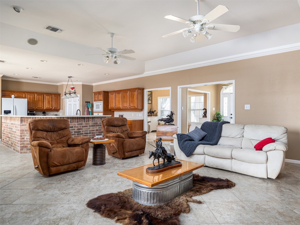 651 County Road 497 Taylor, TX 76574 - Photo 10 of 40 a living room with furniture ceiling fan and a rug