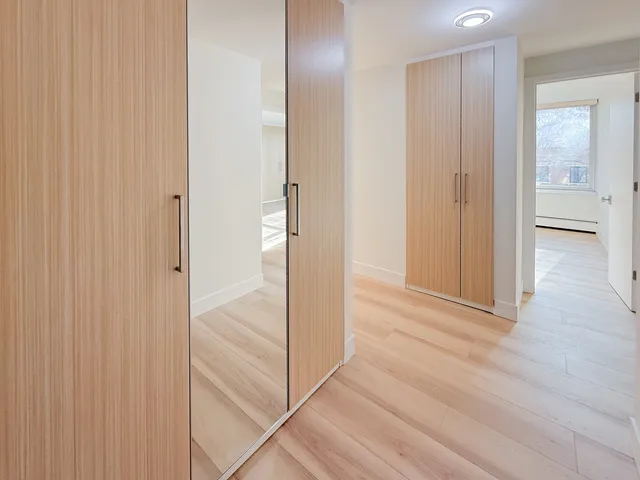 a view of a hallway with wooden floor