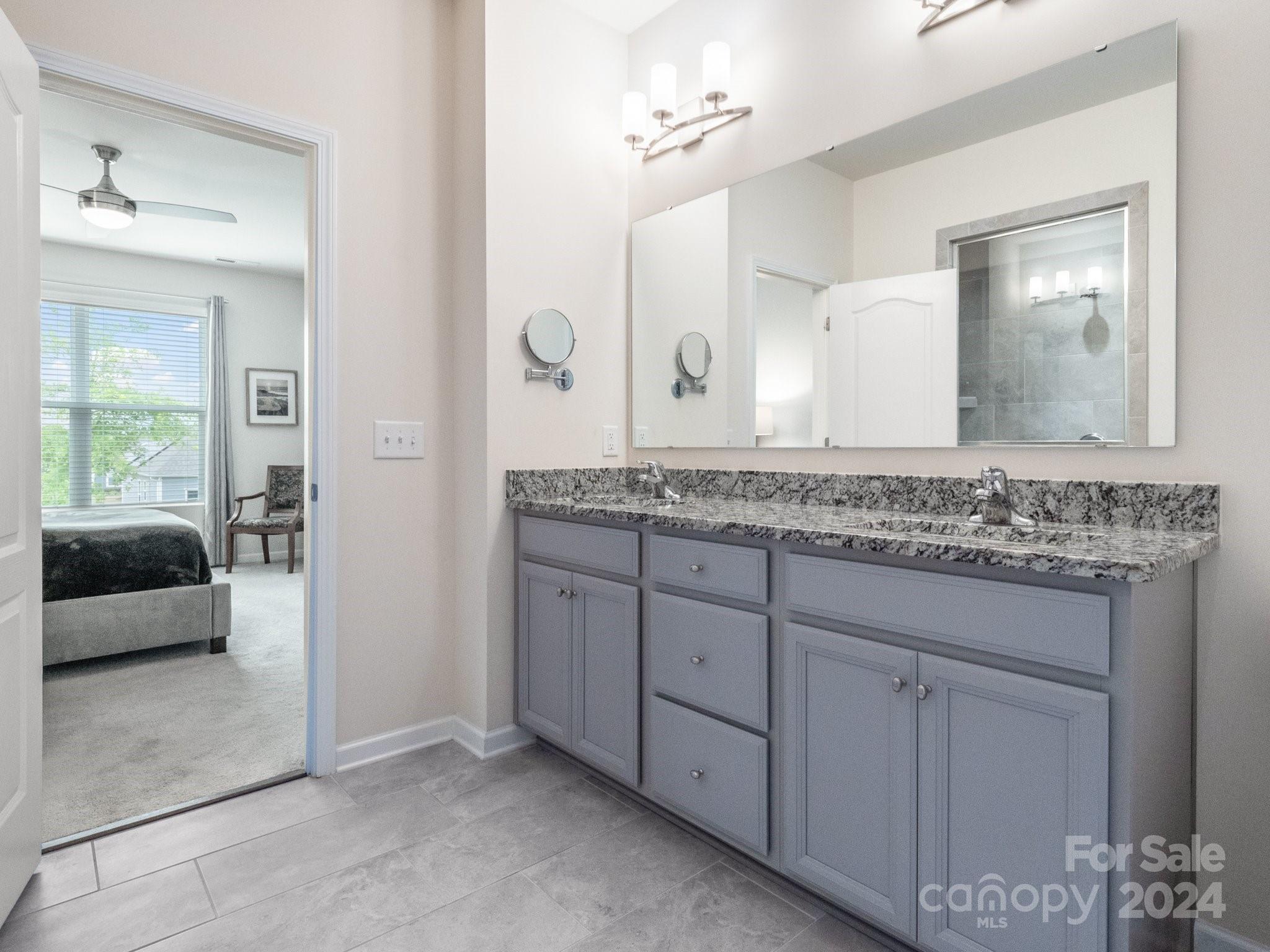 4239 Merrivale Drive Lancaster, SC 29720 - Photo 17 of 33 a en suite bathroom with a granite countertop sink and a mirror