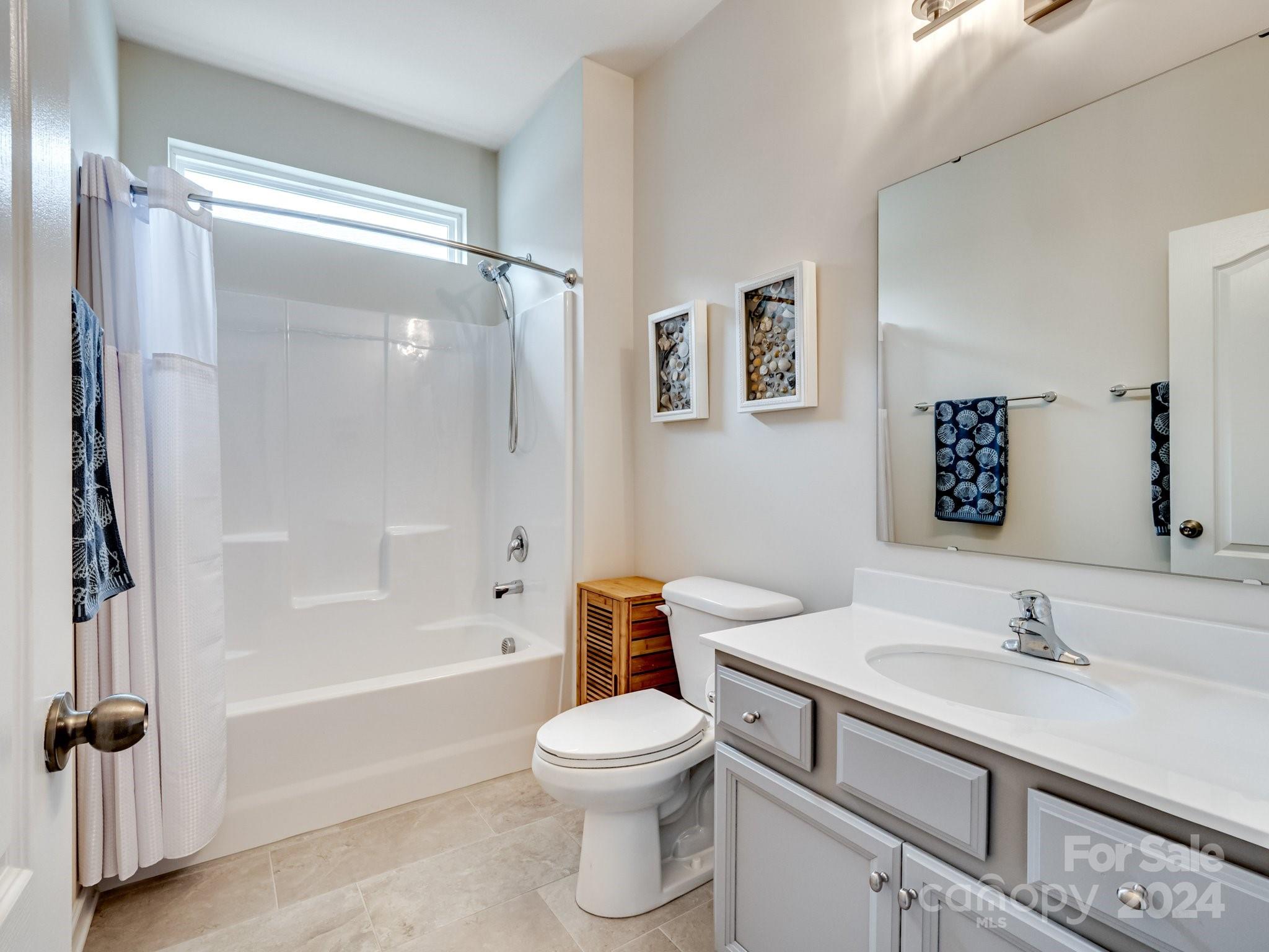4239 Merrivale Drive Lancaster, SC 29720 - Photo 20 of 33 a bathroom with a sink a toilet and a large mirror