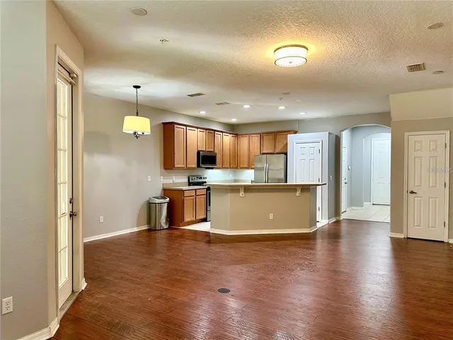 a view of kitchen with cabinets and wooden floor
