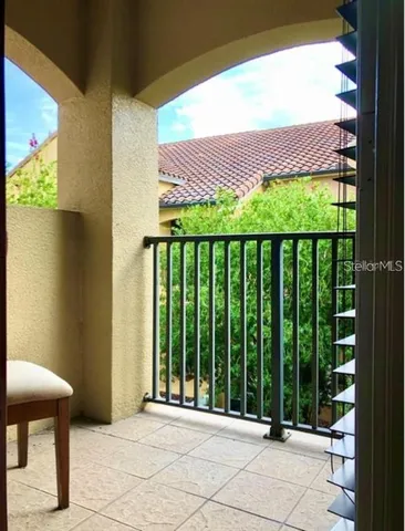 a view of a room with wooden floor chandelier and windows
