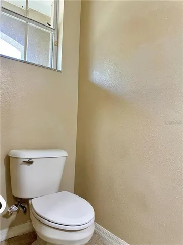 a white toilet sitting next to a shower