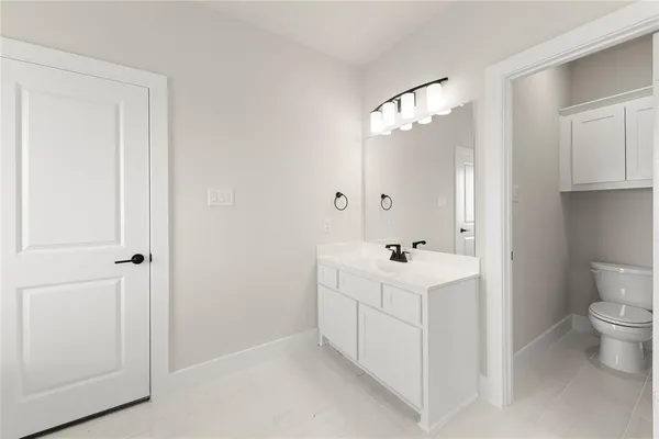 a bathroom with a bathtub sink and mirror