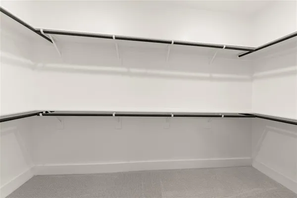 an empty room with windows and couch