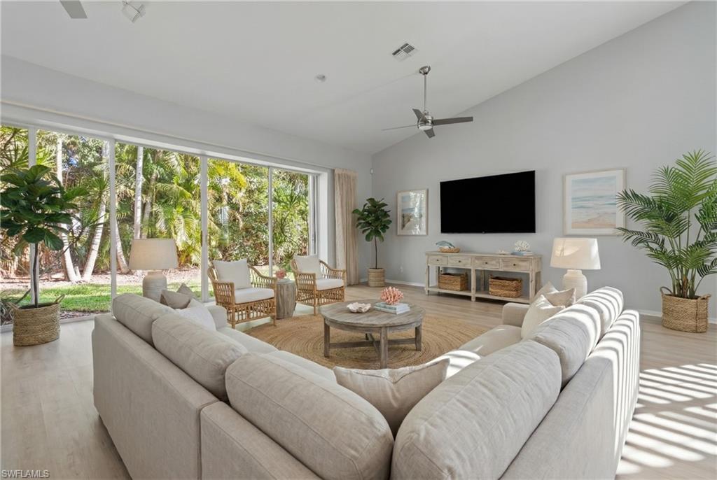 20751 Rivers Ford Estero, FL 33928 - Photo 2 of 36 Living area with wood finished floors, a ceiling fan, and high vaulted ceiling