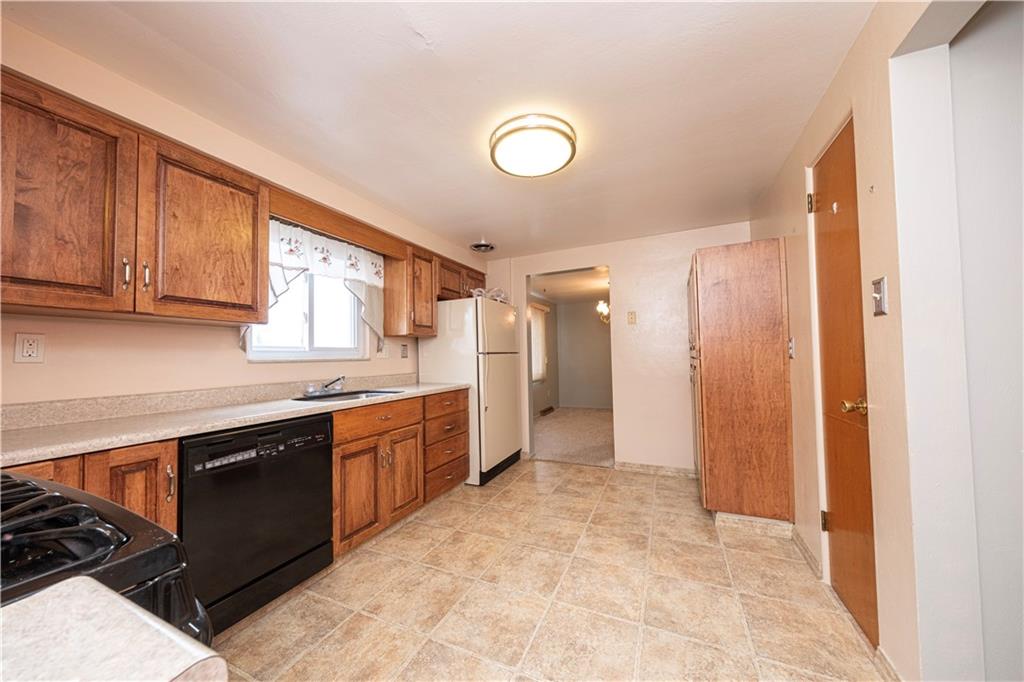 209 Video Drive Homestead, PA 15120 - Photo 15 of 33 a large kitchen with stainless steel appliances granite countertop a sink and cabinets
