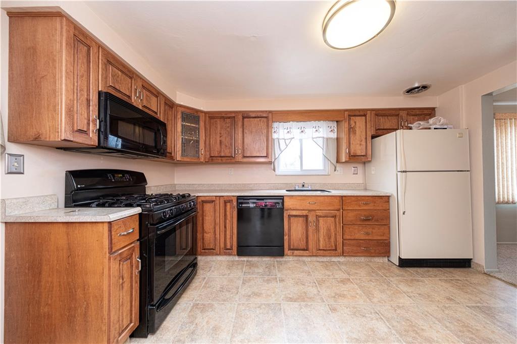 209 Video Drive Homestead, PA 15120 - Photo 16 of 33 a kitchen with stainless steel appliances granite countertop a stove top oven a refrigerator a sink and dishwasher