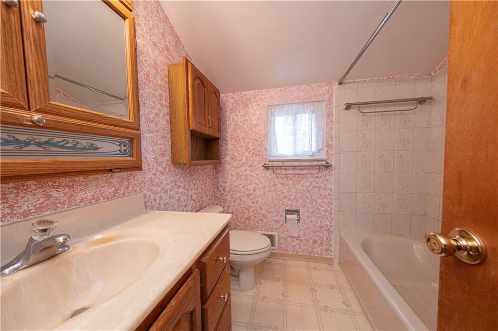 209 Video Drive Homestead, PA 15120 - Photo 19 of 33 a bathroom with a sink a toilet a tub and shower