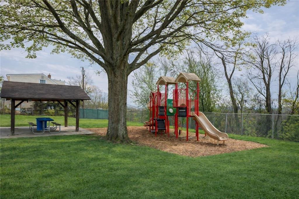 209 Video Drive Homestead, PA 15120 - Photo 33 of 33 a view of playground with a slide and large trees