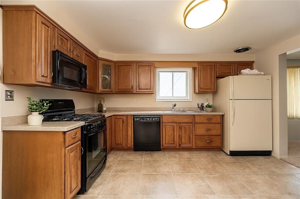 209 Video Drive Homestead, PA 15120 - Photo 4 of 33 a kitchen with cabinets stainless steel appliances and a window
