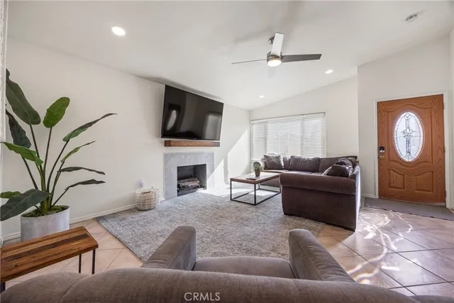 a living room with furniture and a potted plant