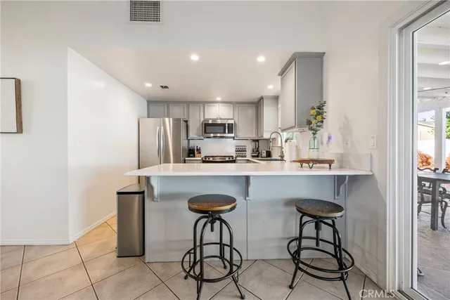a kitchen with stainless steel appliances granite countertop a stove and a refrigerator