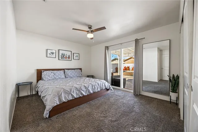 a bathroom with a granite countertop toilet sink and mirror